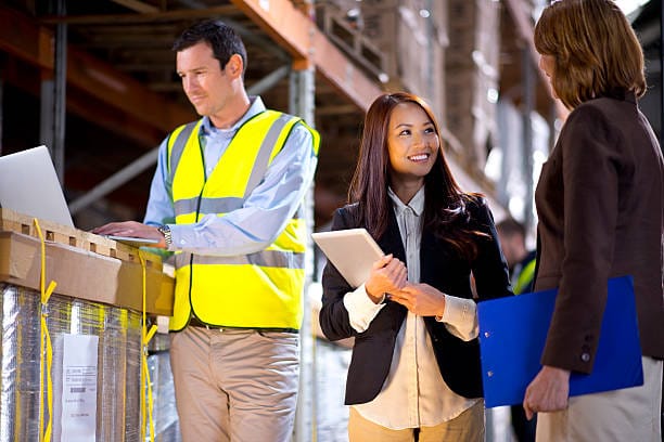 warehouse manager checks something with her supervisor